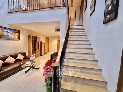 Spacious modern living room with elegant staircase and stylish decor