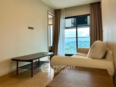Modern living room with a stunning city view, featuring a cozy sofa and elegant wooden furniture.