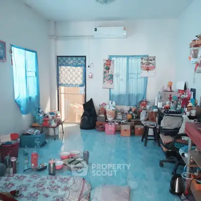 Cozy living room with blue accents and eclectic decor, featuring a comfortable seating area and natural light.