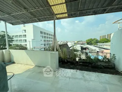 Spacious balcony with urban view, perfect for relaxation and enjoying cityscape.