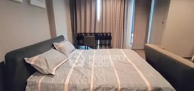 Modern bedroom with stylish decor and cozy ambiance, featuring a comfortable bed and work desk.