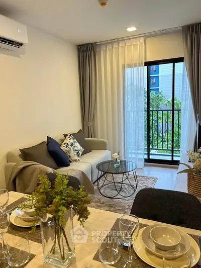 Modern living room with balcony view, stylish decor, and elegant dining setup.
