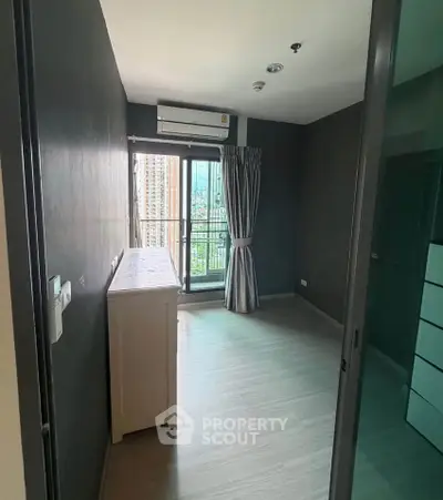 Modern bedroom with balcony view in high-rise apartment