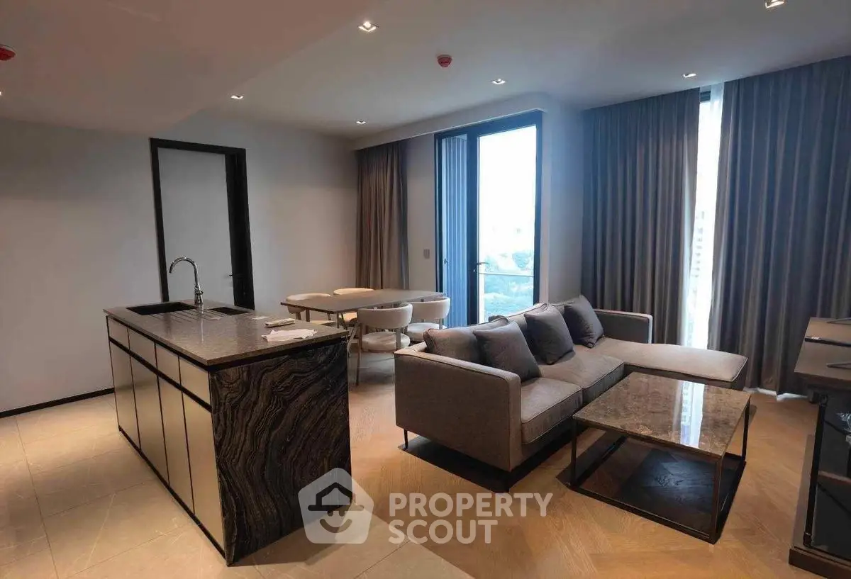 Modern open-plan living room with sleek kitchen island and stylish sofa