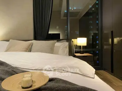 Luxurious bedroom with modern decor and city view, featuring cozy bedding and ambient lighting.