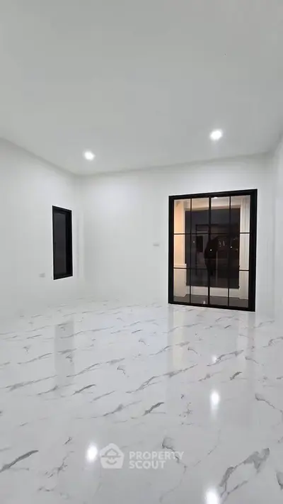 Spacious modern living room with marble flooring and large windows