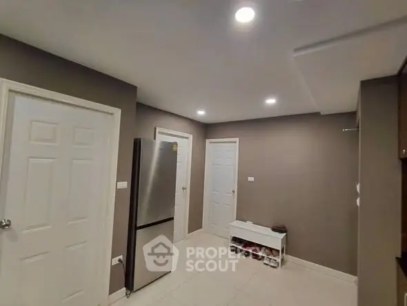 Modern kitchen with stainless steel fridge and ample storage space