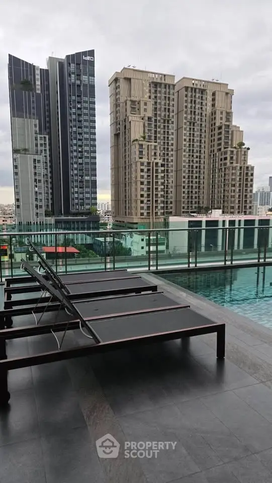 Luxurious rooftop pool with stunning cityscape views and modern lounge chairs.