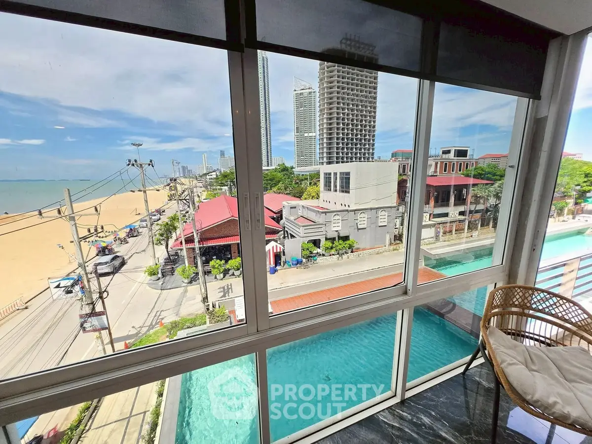 Stunning beachfront view from a modern apartment with pool and balcony.