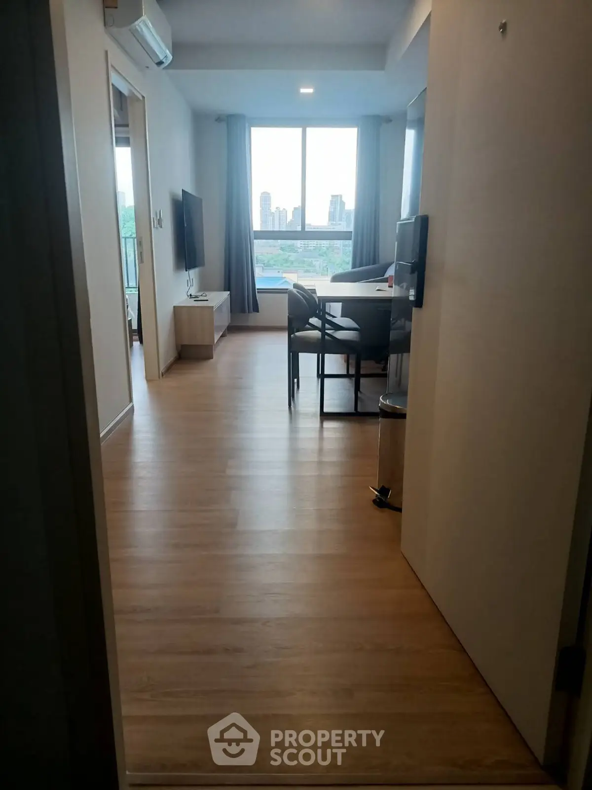 Modern apartment interior with wooden flooring and city view