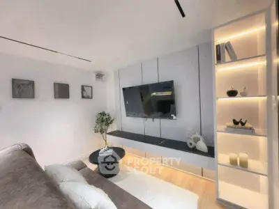Modern living room with sleek TV setup and stylish shelving