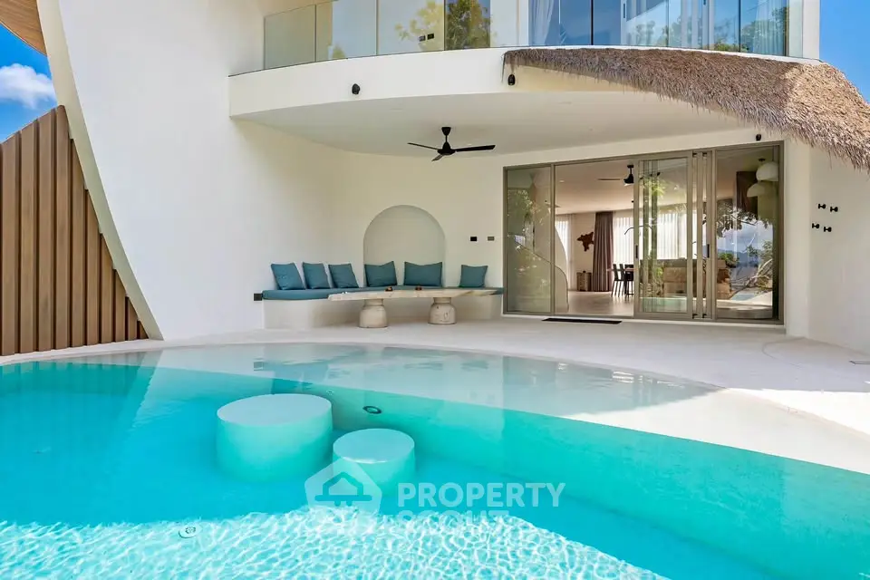 Luxurious modern villa with private pool and stylish outdoor seating area.