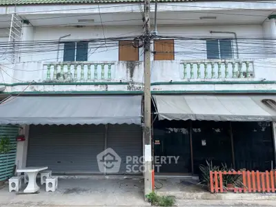 Commercial property with dual storefronts and balcony, ideal for business opportunities.