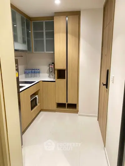 Modern kitchen with sleek cabinetry and built-in appliances in a compact layout.