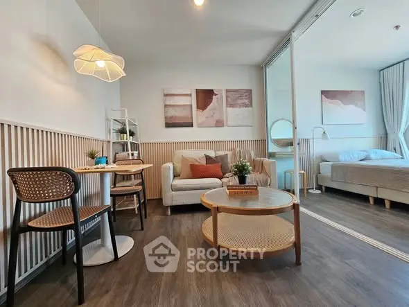 Modern living room with cozy seating and stylish decor in a bright apartment.