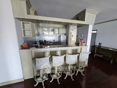 Charming kitchen with bar seating and classic wooden cabinetry