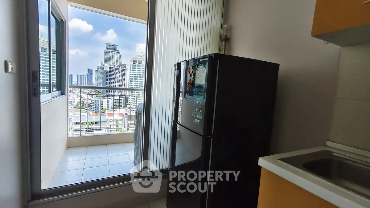 Modern kitchen with balcony view in high-rise apartment