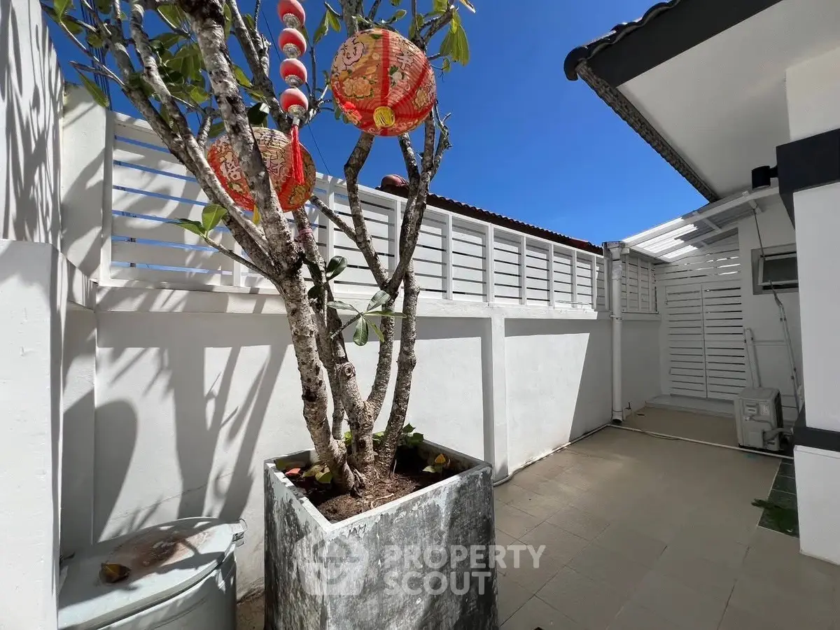 Charming outdoor patio with Asian-inspired decor and vibrant lanterns, perfect for relaxation and entertainment.