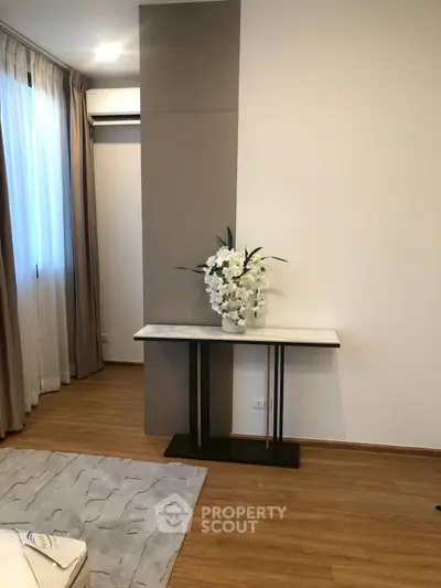 Elegant living room corner with modern decor and wooden flooring