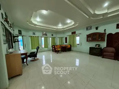 Spacious living room with elegant ceiling design and ample natural light