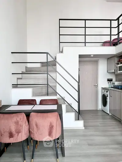 Modern duplex apartment with stylish staircase and cozy dining area