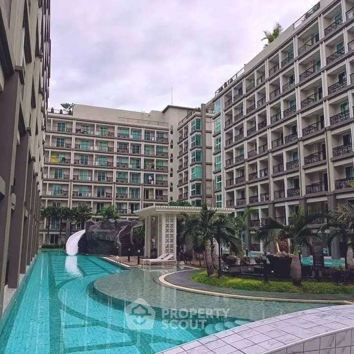 Luxurious apartment complex with stunning pool and modern architecture.