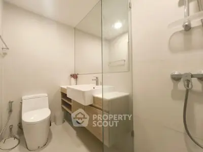 Modern bathroom with sleek fixtures and glass shower enclosure