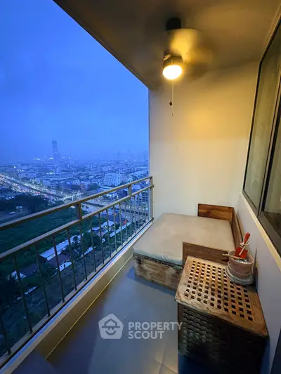 Charming balcony with city view, cozy seating, and ambient lighting at dusk.