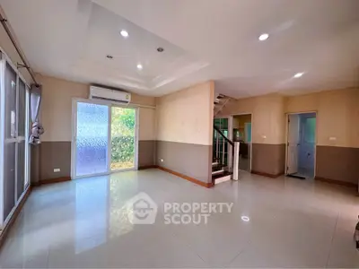 Spacious living room with modern design and large windows for natural light.