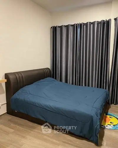 Cozy bedroom with modern decor and elegant curtains, perfect for relaxation.