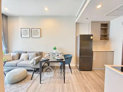 Modern open-plan living room and kitchen with stylish decor and natural light.