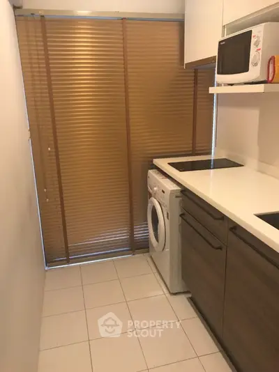 Compact kitchen with modern appliances and sleek cabinetry
