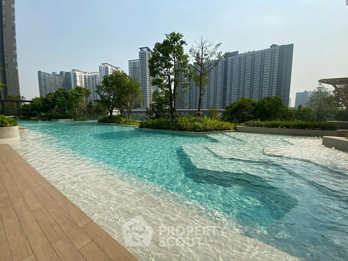 Luxurious residential complex with stunning outdoor pool and lush greenery, offering a serene urban oasis.