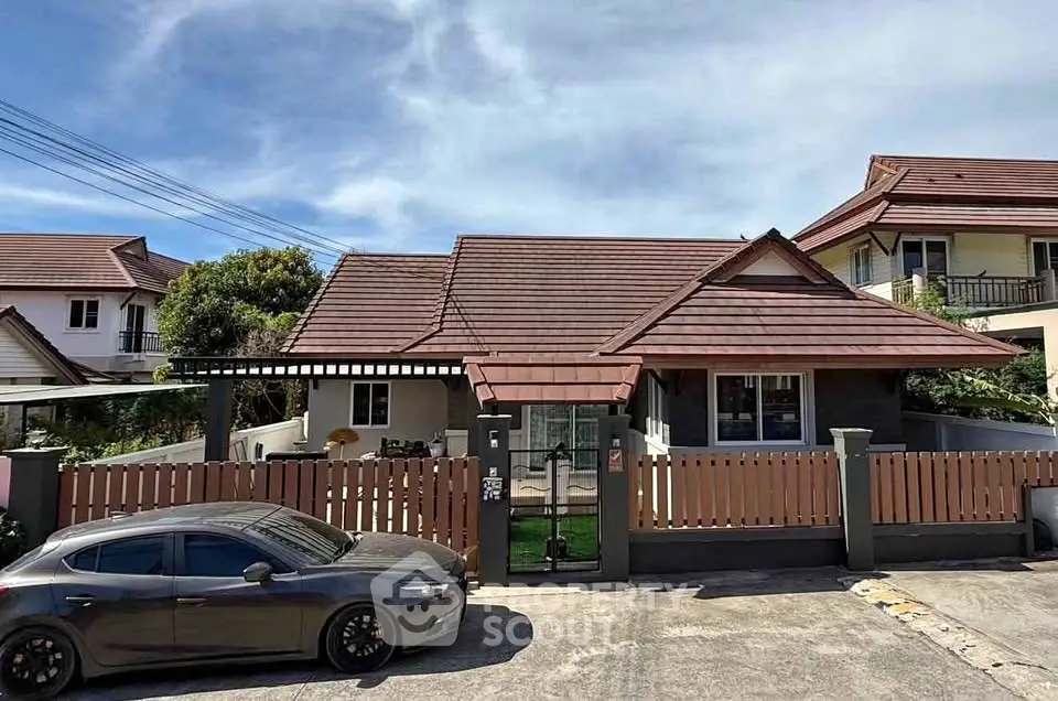 Charming suburban house with modern roof and fenced yard, perfect for family living.