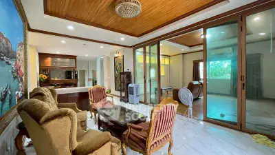 Spacious living room with elegant furniture and wooden ceiling accents