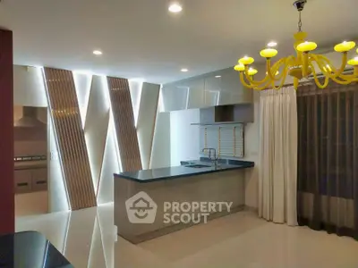 Modern kitchen with sleek design, featuring open layout and stylish lighting, perfect for contemporary living.