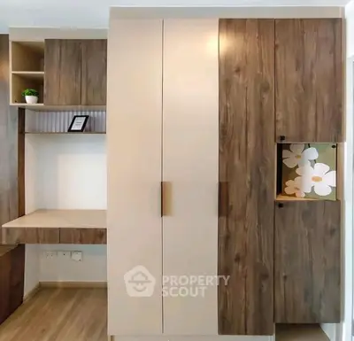 Modern built-in wooden storage unit with desk in stylish interior design.