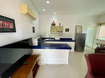 Modern kitchen with sleek blue countertops and stainless steel appliances