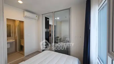 Modern bedroom with ensuite bathroom and large window for natural light
