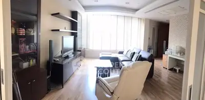 Spacious living room with modern furniture and large windows