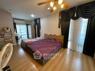 Spacious bedroom with elegant decor and natural light