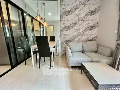 Modern living room with stylish dining area and cozy sofa, featuring elegant lighting and marble accent wall.