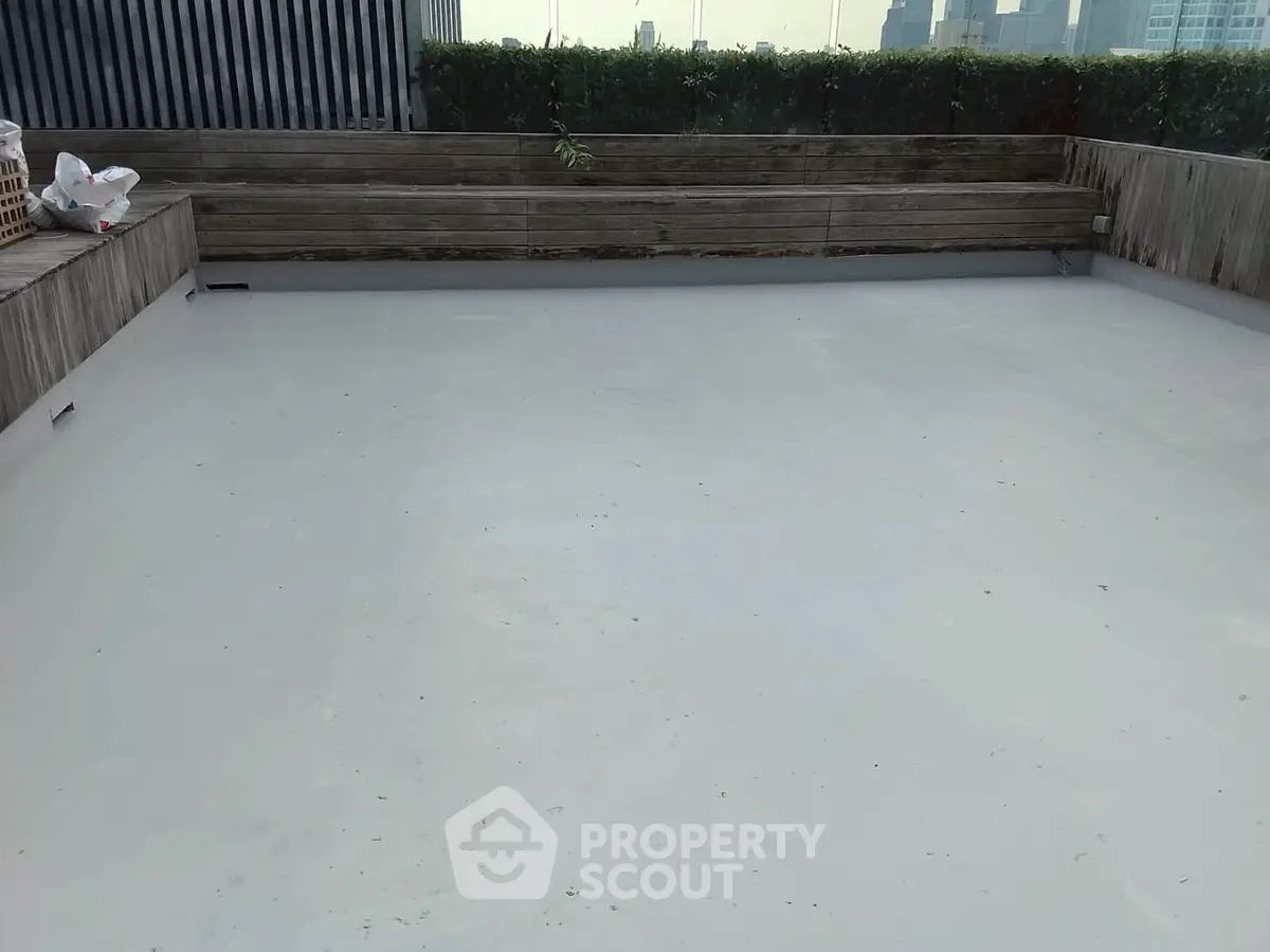 Spacious rooftop area with city skyline view, perfect for outdoor gatherings.