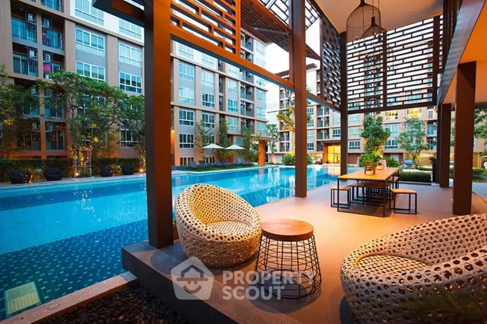 Luxurious poolside area with modern seating in a high-end apartment complex.