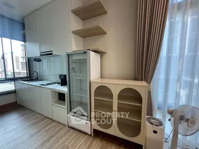 Modern kitchen with sleek cabinetry and large windows in a stylish apartment