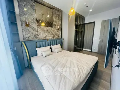 Luxurious bedroom with elegant decor and modern furnishings, featuring a plush bed and stylish lighting.