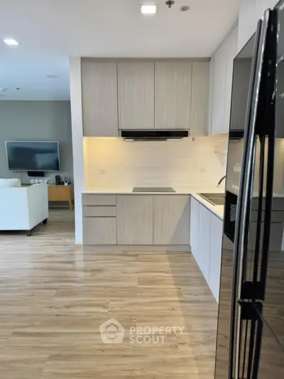Modern kitchen with sleek cabinetry and open layout in stylish apartment