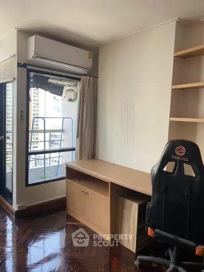Modern study room with balcony view, featuring a sleek desk and ergonomic chair, perfect for productivity.