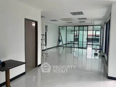 Spacious modern interior with glossy floors and large windows for natural light.