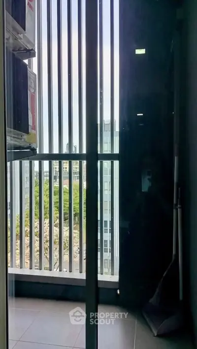 Modern apartment balcony with city view and sleek railing design.